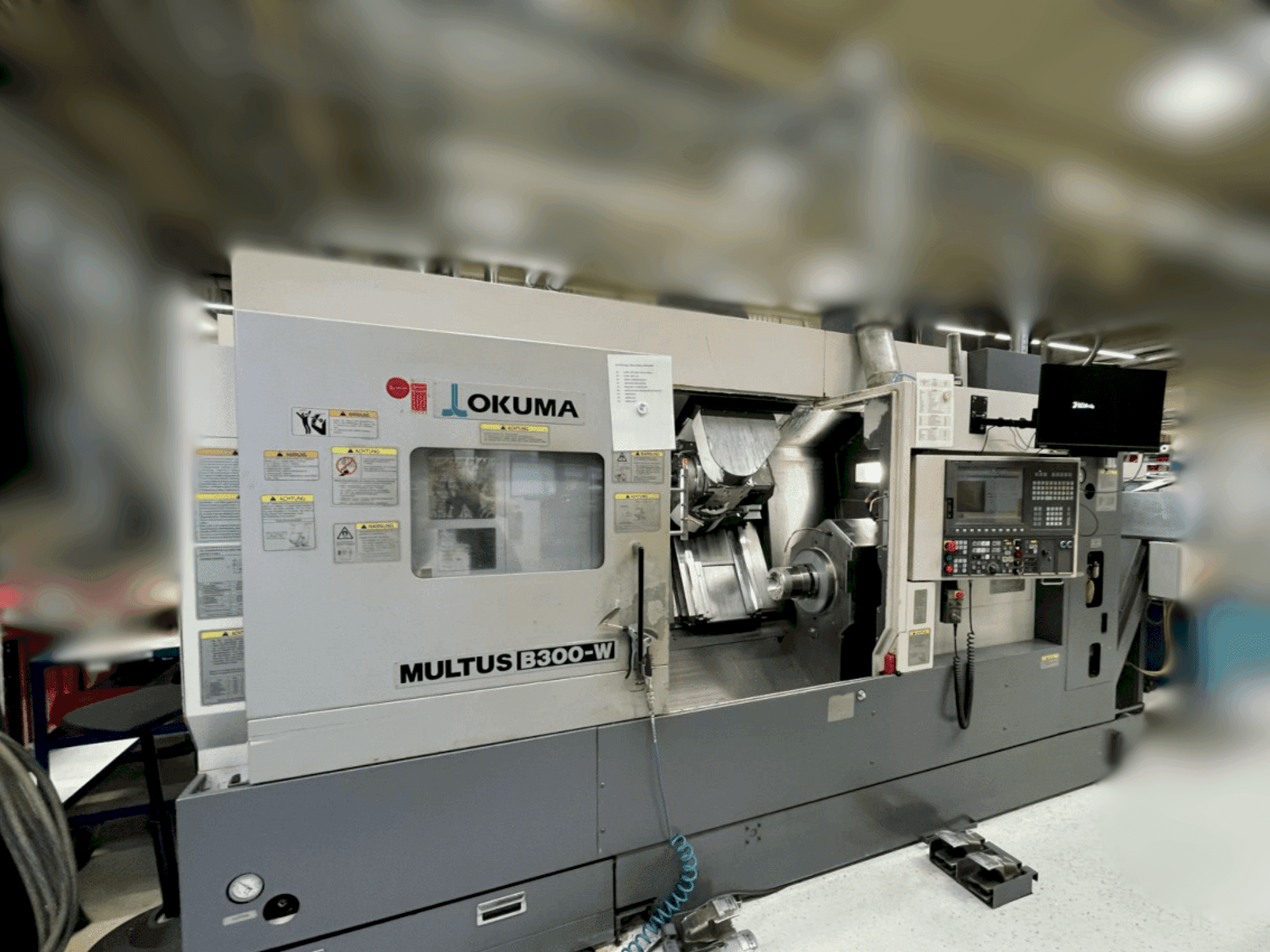 Mašīnas Okuma Multus B300-W pretskats